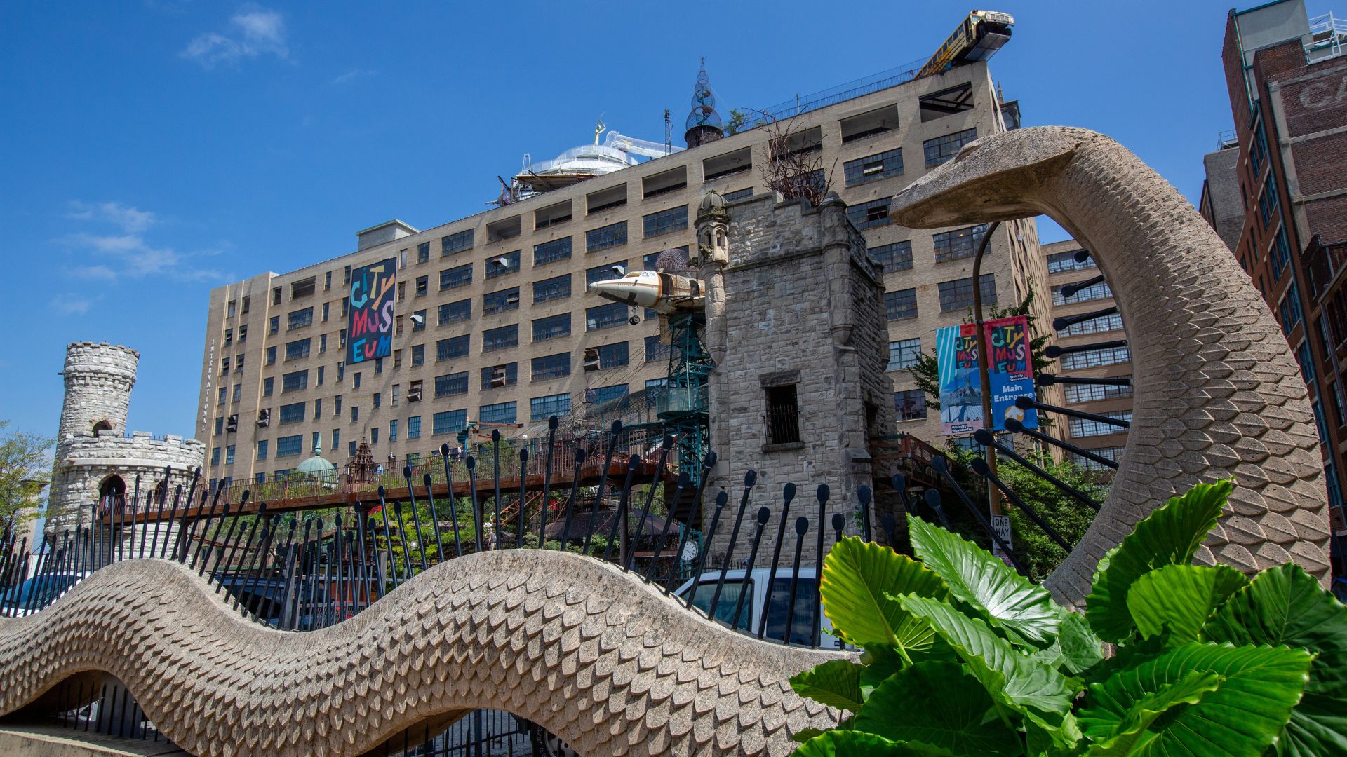 Factory building with a large snake-like animal in the foreground
